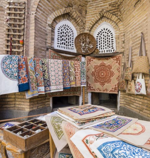 The wide range of the hand made carpets, traditional knotted Uzbek silk rugs, embroidered tablecloths and bed linen in the small bazaar, Khiva, Uzbekistan, Central Asia
